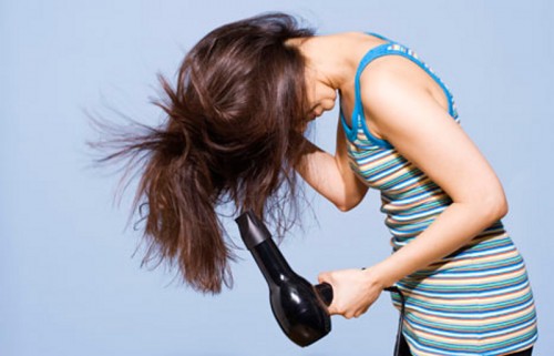 Woman blowdrying hair